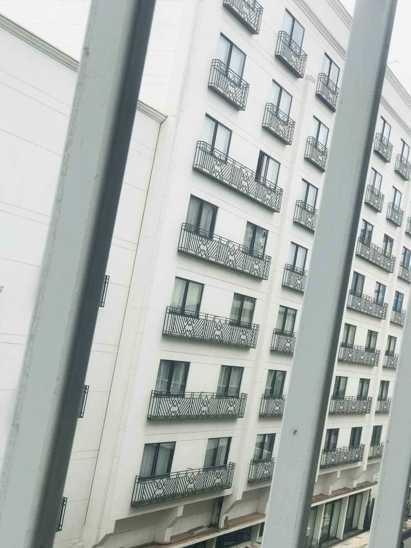 Tall apartment building with rows of balconies